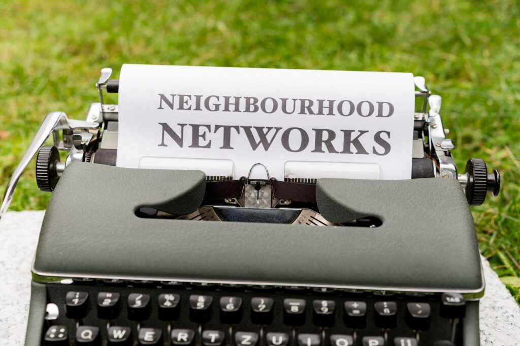 A typewriter with the words neighborhood networks on it